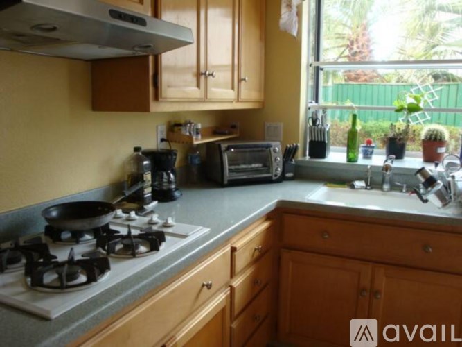 A kitchen with a stove, oven, and a window.