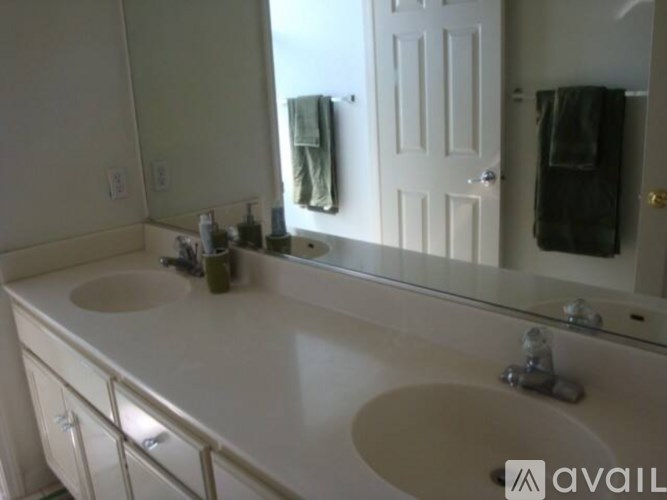 A bathroom with two sinks and a large mirror.
