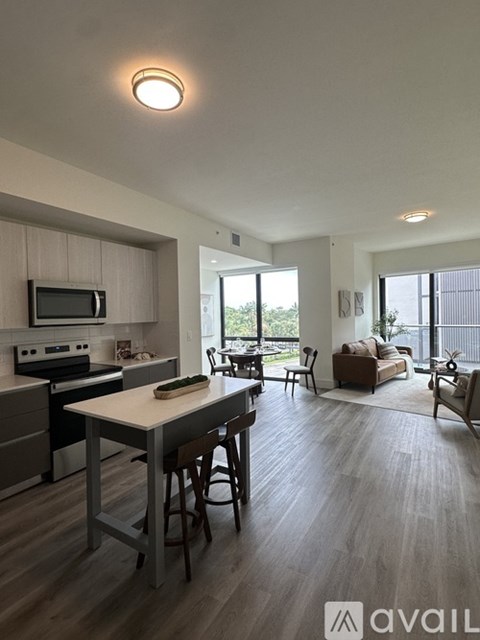 A modern kitchen with a dining table and chairs.