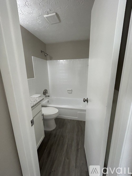 A small bathroom with a toilet, sink, and bathtub.