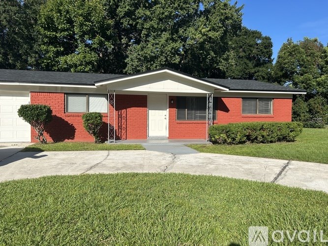 A red brick house with a white garage door.