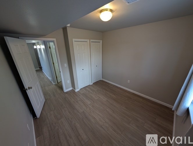 A bathroom with a shower curtain and a shower head.