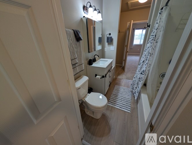 A bathroom with a toilet, sink, and shower.