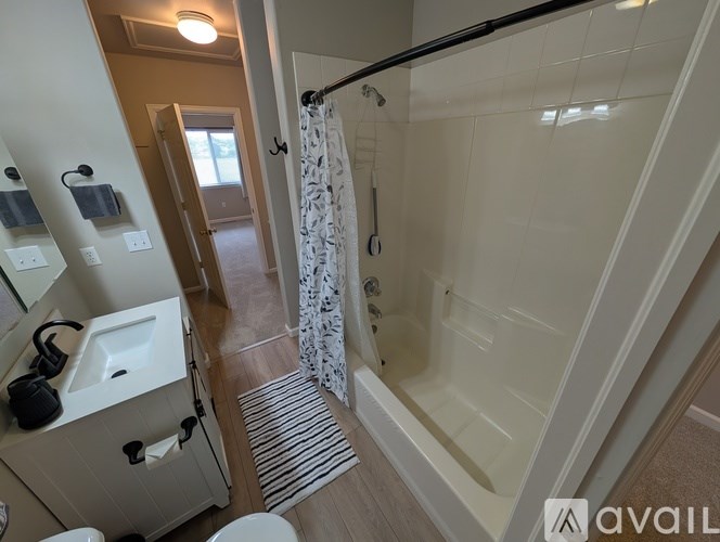 A bathroom with a white sink, toilet, and bathtub.