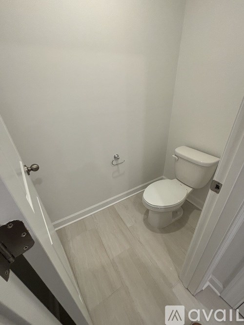A white toilet in a small bathroom.