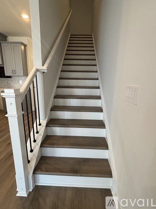 A staircase with white railings and wooden steps.