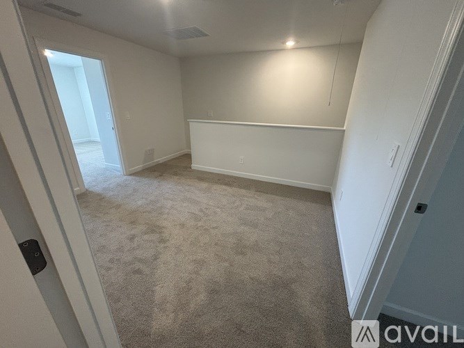 A room with a carpeted floor and white walls.
