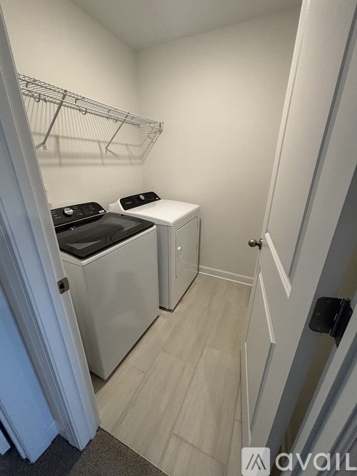 A small laundry room with a washer and dryer.