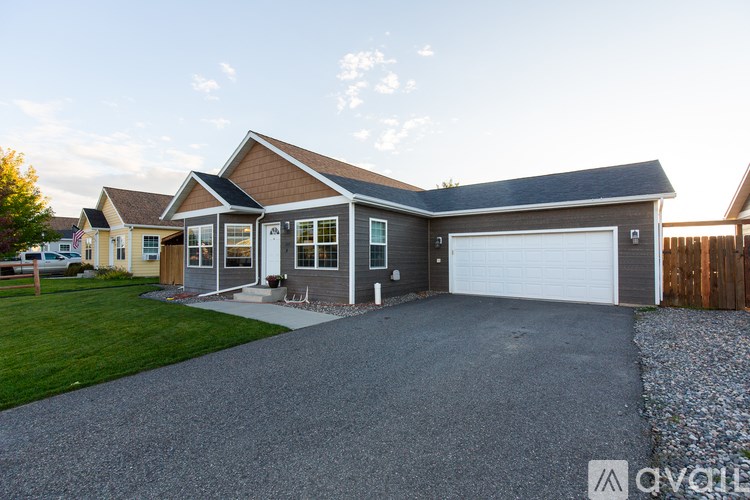 A house with a garage and a driveway in front.