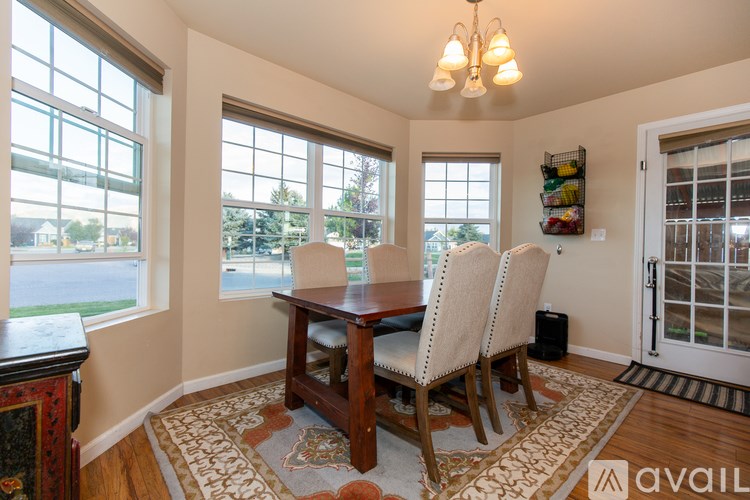 A dining room with a table and chairs.