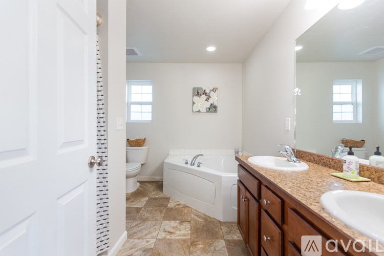 A bathroom with a toilet, sink, and bathtub.