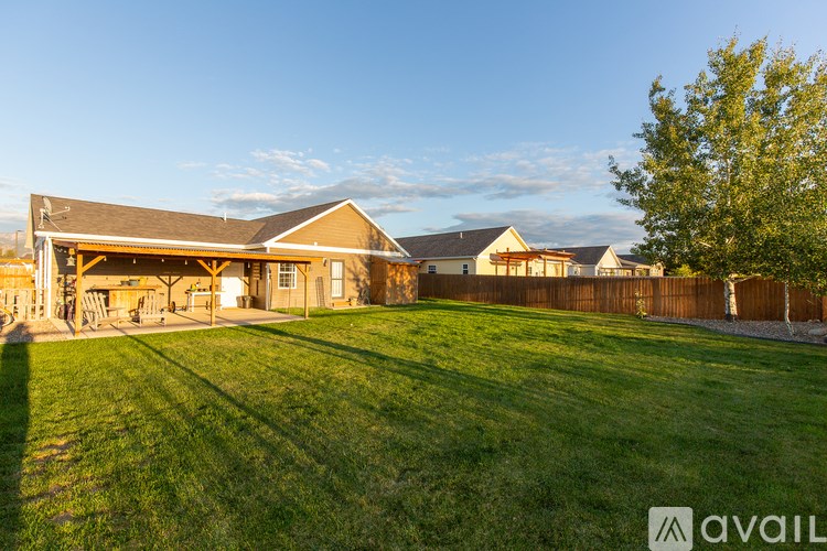 A house with a large lawn in front of it.