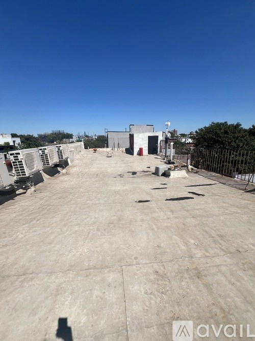 A large, empty parking lot with a building in the background.