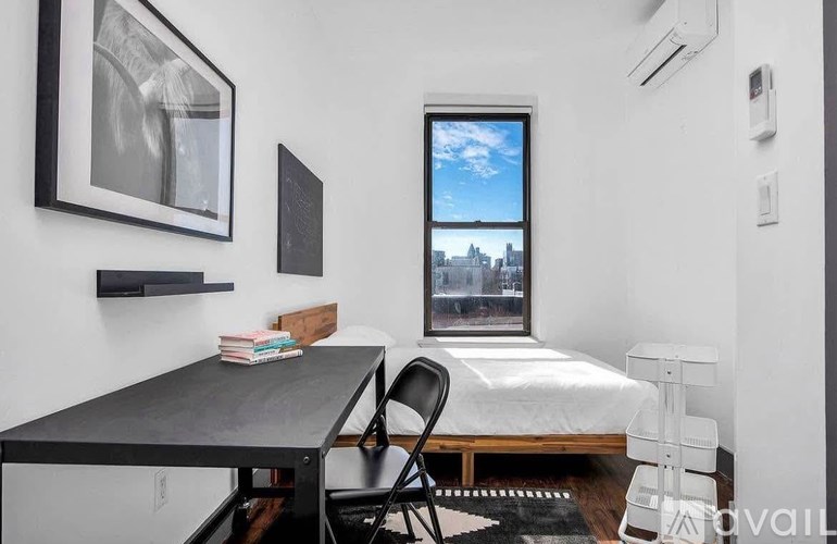 A black table with a chair and a window with a view of a cityscape.