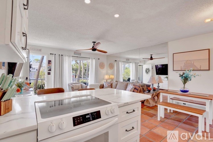 A kitchen with white appliances and a white countertop.