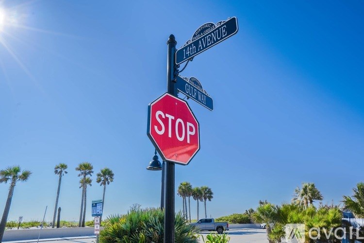 A red stop sign is in the foreground with street signs for 14th Avenue and Gulf Way.