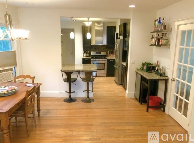 A kitchen with a table and chairs in the middle of the room.