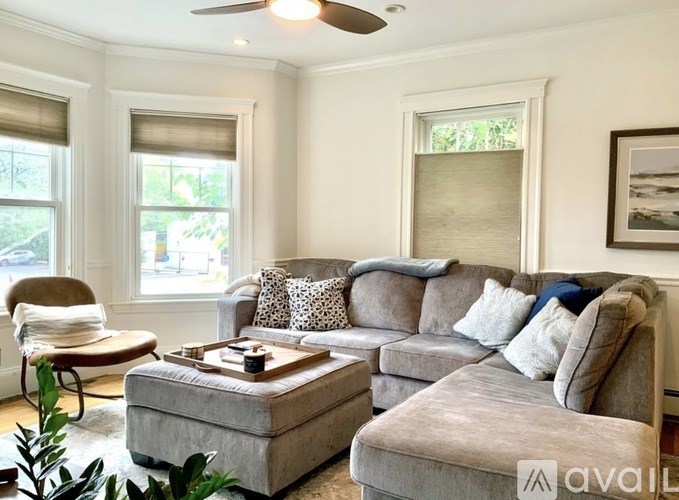 A living room with a grey couch and a coffee table.