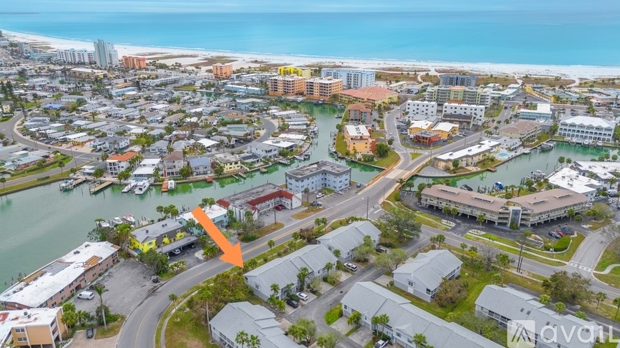 An aerial view of a coastal town with a large body of water and buildings.