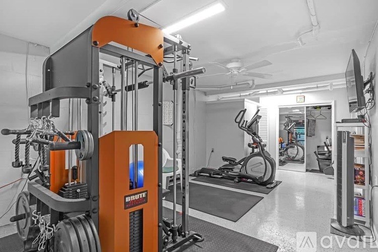 A gym with a Brute weight machine and other exercise equipment.