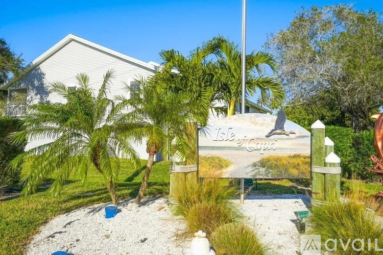 A sign that says "Isle of Capri" is in front of a house.