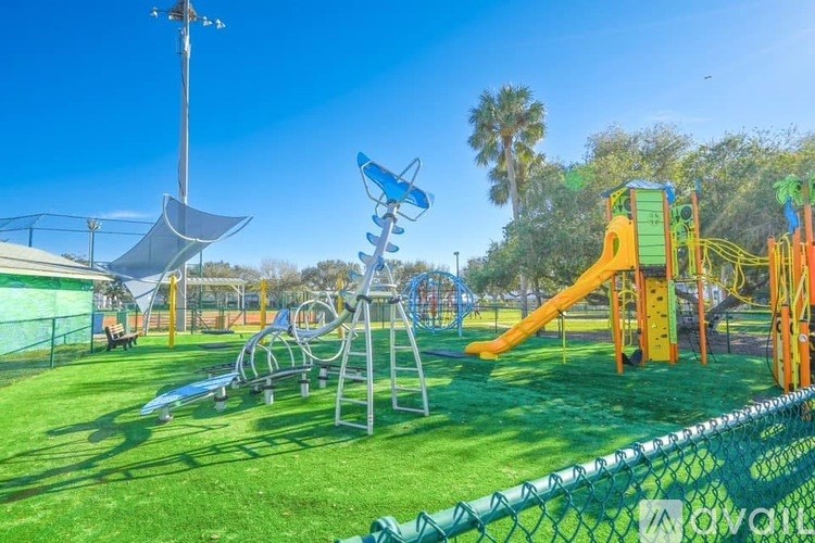 A playground with a yellow slide and a blue and white slide.