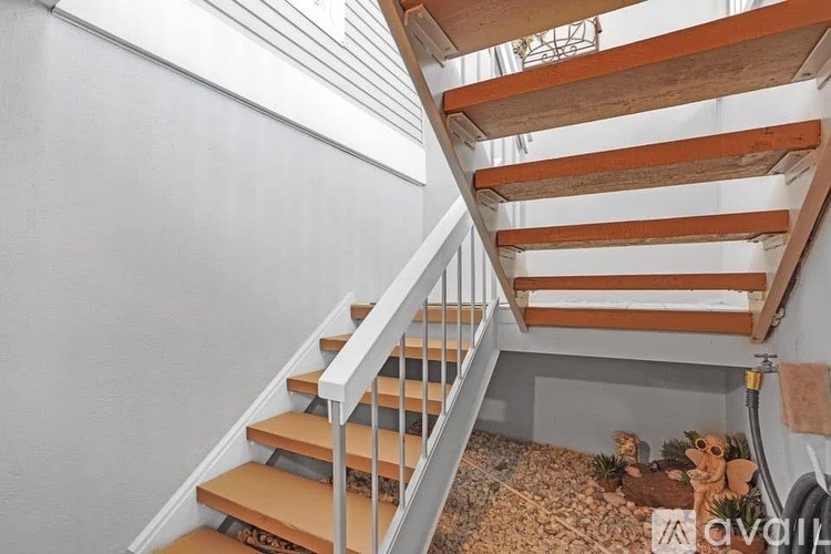 A wooden staircase with a white railing.