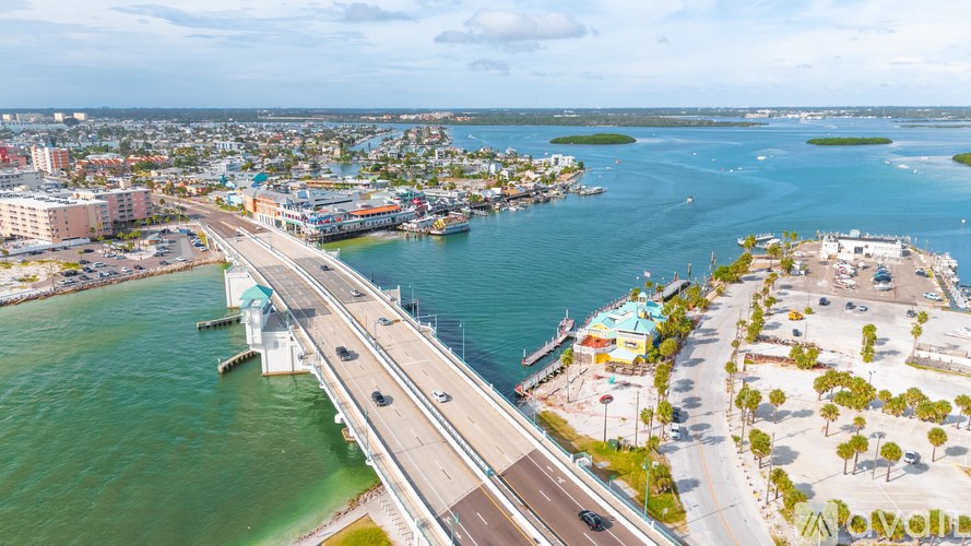 A bridge over a body of water with a city in the background.