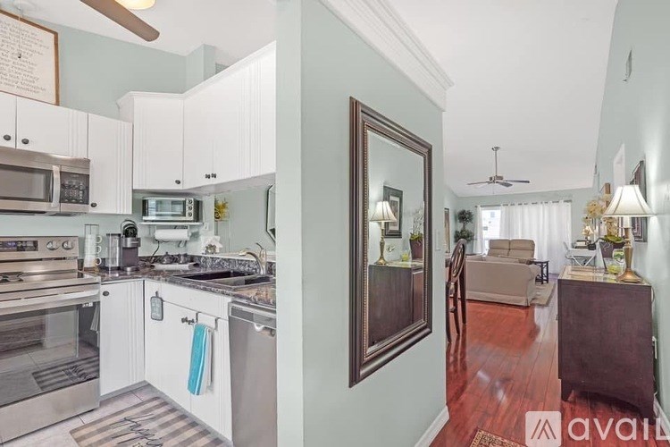 A kitchen with white cabinets and a stainless steel oven.