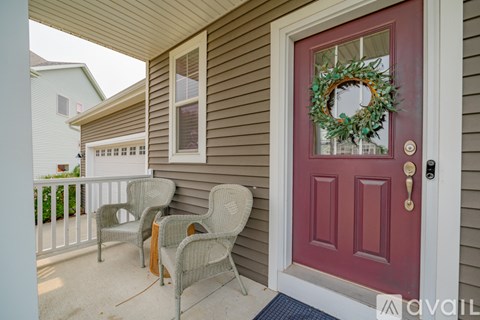 A red door with a wreath on it.