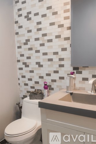 A white toilet sits next to a sink in a bathroom.