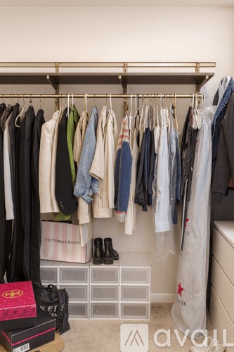 Clothes hanging on a rack in a room.