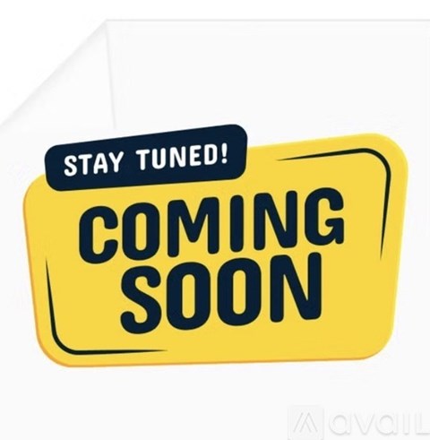 A yellow sign with the words "STAY TUNED! COMING SOON" on it.