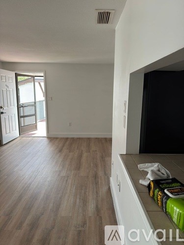 A living room with a television and a book on the counter.
