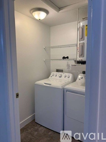 A small bathroom with a washer and dryer.