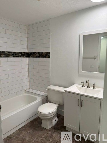 A bathroom with a toilet, sink, and bathtub.
