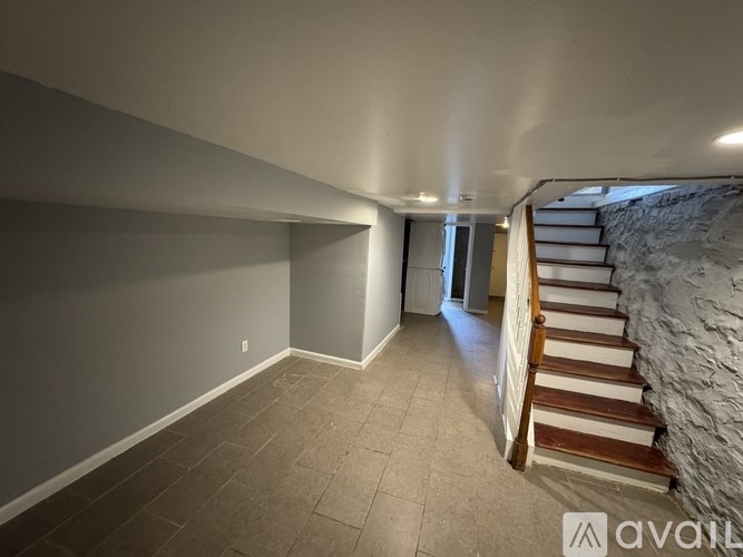 A room with a staircase leading to a doorway.