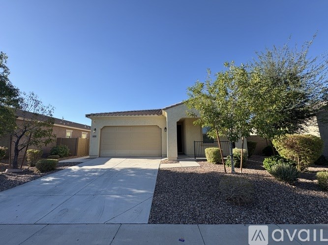 A house with a garage and a driveway is available for sale.