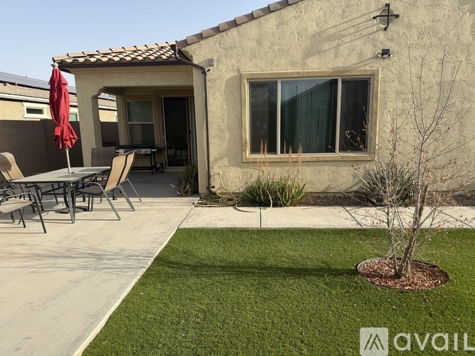 A house with a patio and a tree.