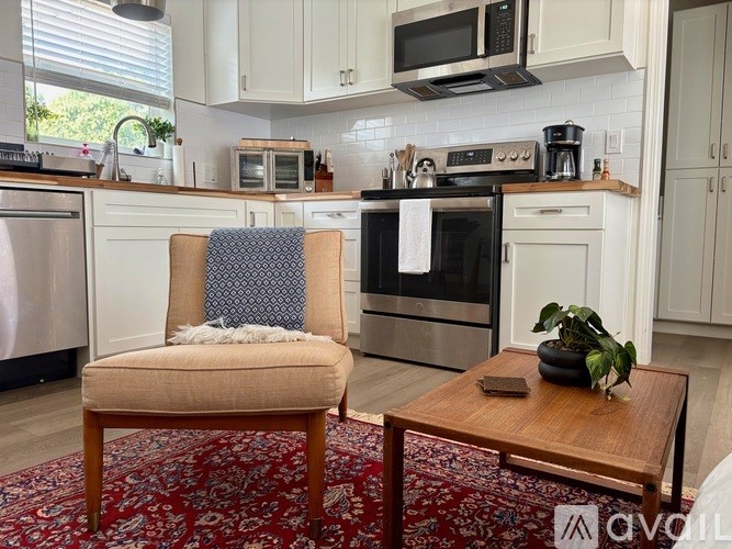 A kitchen with a chair and a table.