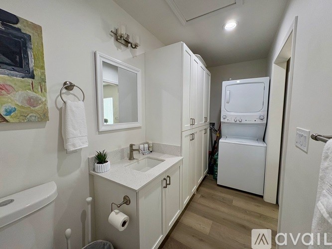 A bathroom with a white tub, sink, and toilet.