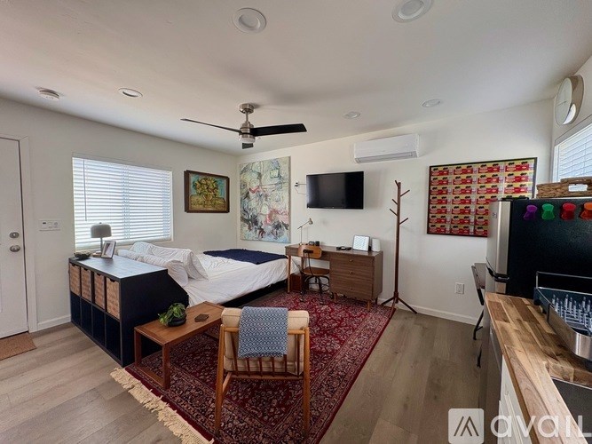 A bedroom with a bed, desk, and chair.