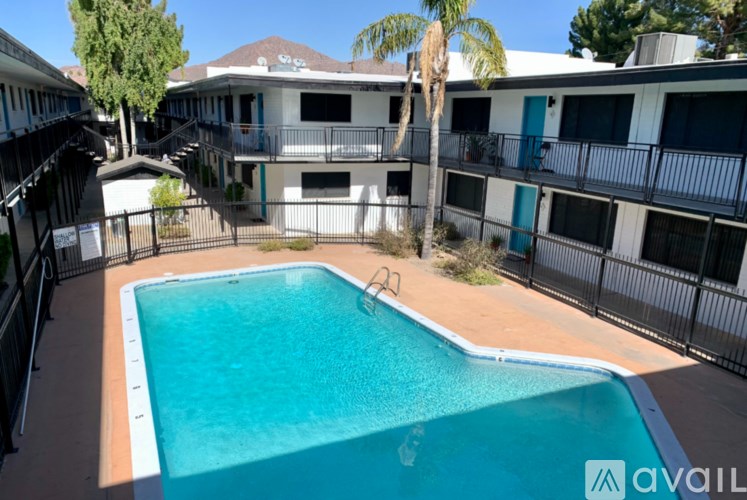 A pool in a courtyard surrounded by a fence.