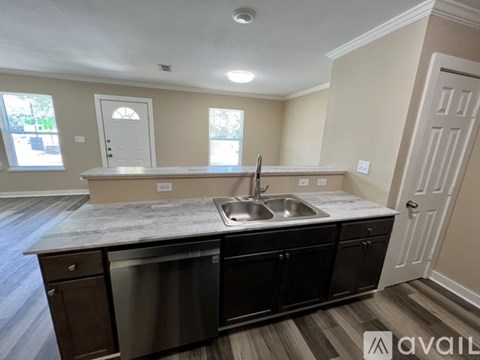 A kitchen with a marble countertop and stainless steel appliances is available for rent.