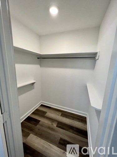 A room with a wooden floor and white walls.