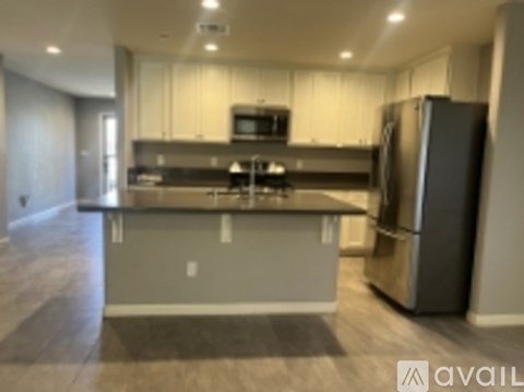 A modern kitchen with a refrigerator on the right side.