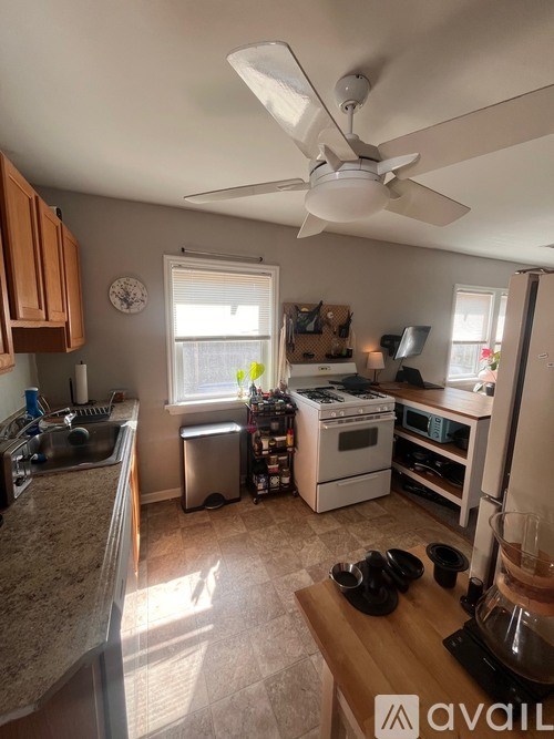 A kitchen with a fan and a window.