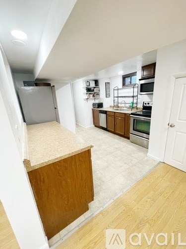 A kitchen with wooden cabinets and a white fridge.