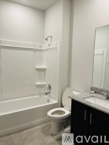 A bathroom with a toilet, sink, and bathtub.