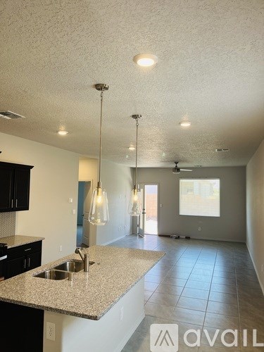 A kitchen with granite countertops and a sink.